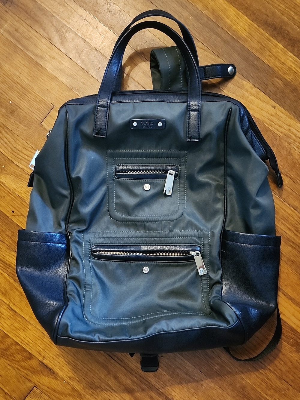 Tutilo Brand Olive Green Backpack Tote with Black Trim and gold accents.